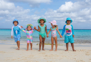 group of kids on the beach wearing Flap Happy SS24 collection